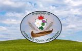 OSM Township logo, sitting on green grass with blue sky above